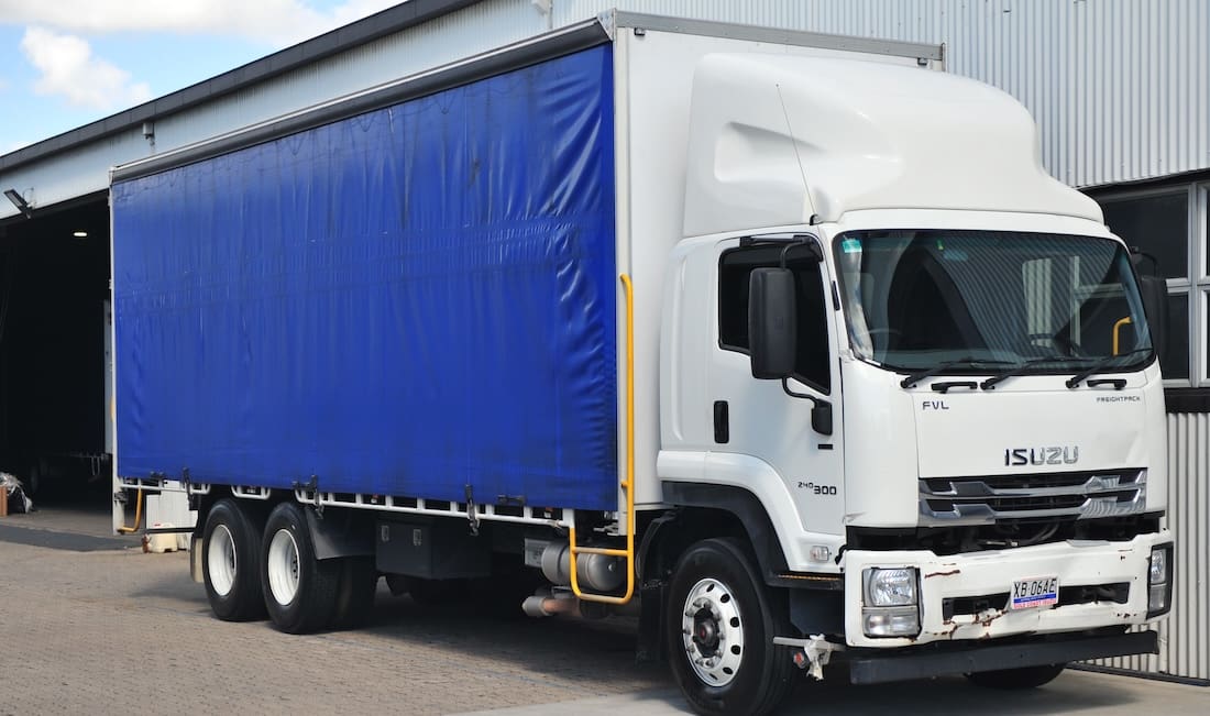 Kanga Couriers Isuzu truck with blue curtains